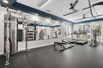 A spacious home gym with a variety of exercise equipment.